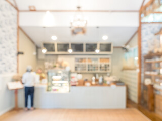 Blurred cafe and bakery interior background with warm lighting and clean modern design, creating soft bokeh atmosphere ideal for coffee shop promotion, lifestyle branding, and cozy workspace concept. © tete_escape