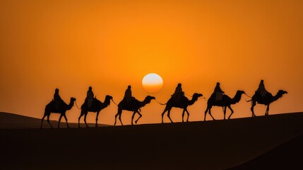 Silhouetted camel caravan walking across desert dunes at sunset beneath a vibrant orange sky.