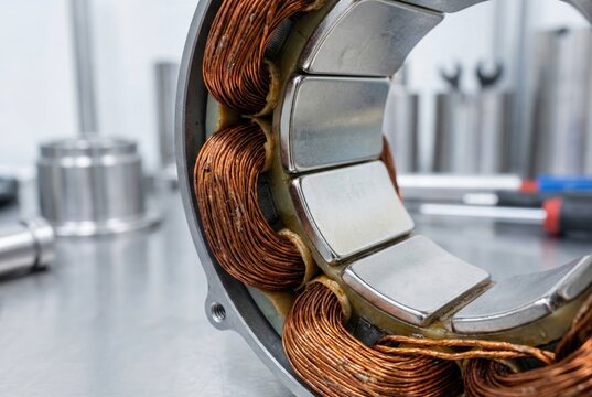 Close up of stator copper coils and silver magnets in a modern industrial electric motor