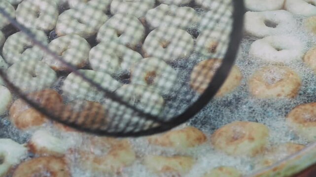 Close-up video of freshly fried lokma dessert served in a tray. Lokma is a traditional Turkish sweet distributed to the community after funerals as an act of charity in Islamic culture. Authentic real