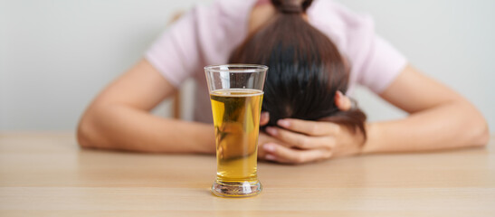 Stressed woman drinking beer alone with problem. Exhausted drunk woman looking stressed and sleepy. Alcohol addiction, Alcoholism, emotional distress and mental health concept