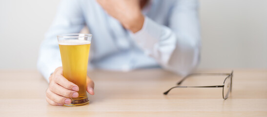 Stressed man drinking beer alone with problem. Exhausted drunk man looking stressed and sleepy....