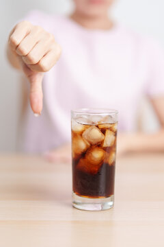 Healthy woman hand thumbs down to soft drink and soda, say no to sugar and carbonated beverage, healthy lifestyle, Acid reflux, Heartburn and Gastritis concept