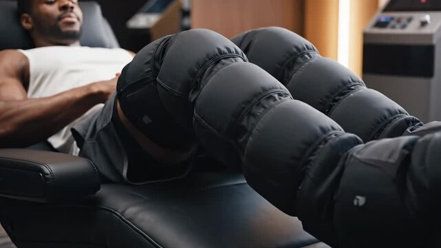 Man relaxing with compression therapy on legs.