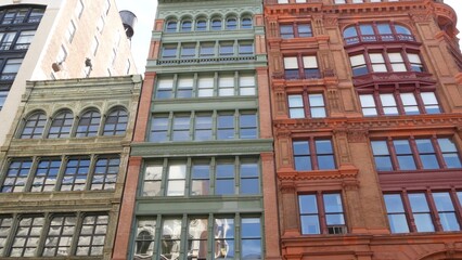 Fototapeta premium New York City urban buildings architecture, Manhattan Broadway street United States of America. Red brick classic house, USA. Typical old historic real estate property in NYC.