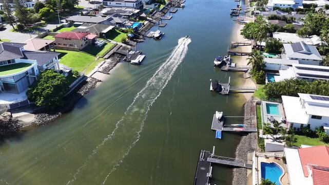 Aerial View of Boat Cruising Through Gold Coast Canal Waterfront Homes