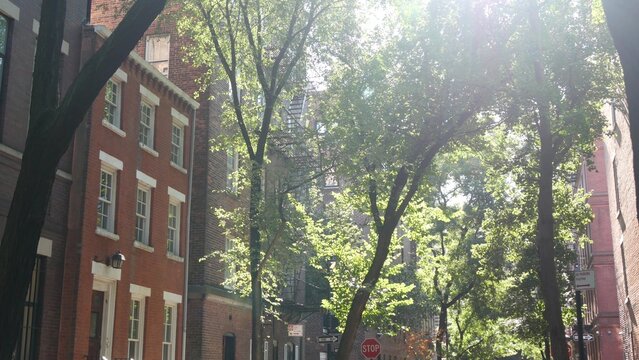 New York City urban residential buildings architecture, Manhattan classic street, Greenwich village, United States of America. Typical red brick house in NYC, real estate property in USA. West village