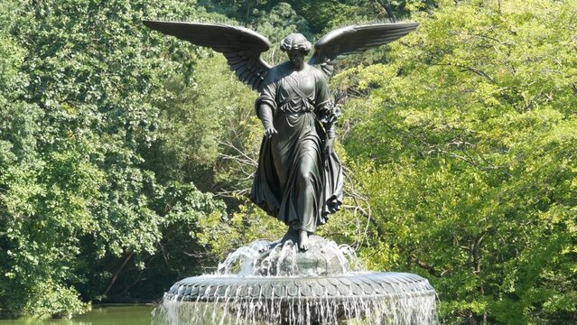 New York City Central Park Bethesda Fountain, angel statue by Bethesda Terrace on summer day, United States. Greenery and sculpture in morning. Autumn fall leaves and green trees in NYC Manhattan, USA