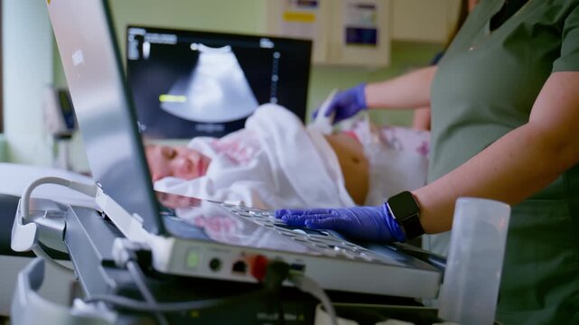 Doctor performing abdominal ultrasound examination for a young girl during medical checkup in hospital clinic.