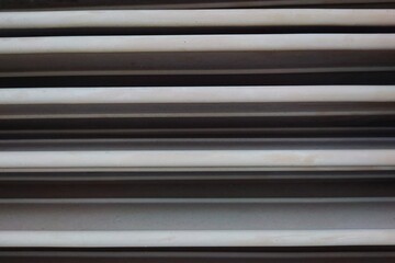 Fototapeta premium Industrial gray metal rolling shutter door texture for urban background