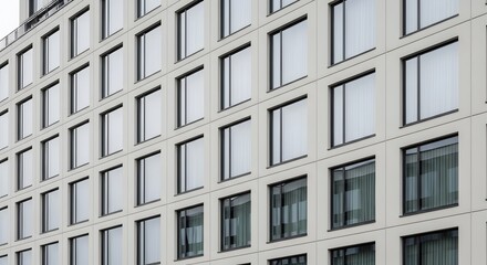 Obraz premium Modern office building facade with repetitive window pattern for corporate identity projects and architecture visualizations