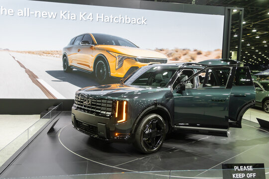 2026 Kia Telluride SUV and K4 hatchback display at auto show. At 2026 Detroit auto show