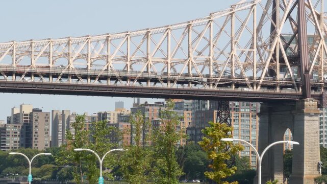 New York City Manhattan Midtown, Queensboro bridge architecture in United States. Urban transport bridge. Metallic bridge over East River esplanade in East Side. Urban park near Roosevelt island.