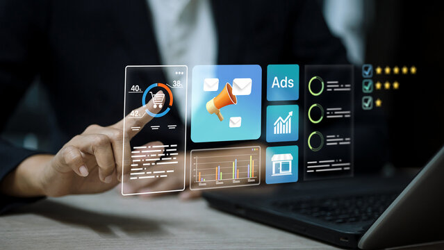 Person touching virtual marketing dashboard with advertising icons and data analytics graphs.