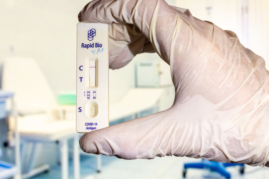 Hand holding covid-19 rapid antigen test kit in medical environment hospital background