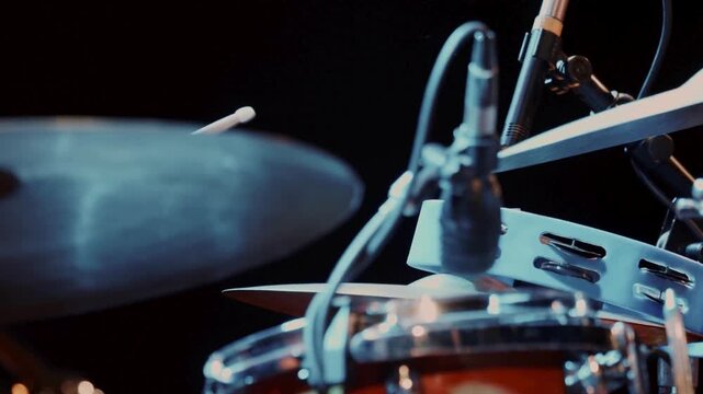 person energetically hit on the plates drum Closeup View with Neon Lighting Atmosphere Blue stage lighting Drummer with drums while performing HD