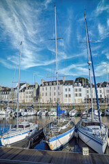 Fototapeta premium Vannes, beautiful city in Brittany, a traditional boat in the harbor, with typical houses 