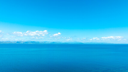 Tropical Nature clear sky and summer sea water under a clear blue sky with beautiful clouds and bright sunlight. Perfect for summer vacation and travel background	