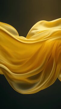 Elegant yellow silk fabric drifting in calm slow motion creating soft golden textile waves. Perfect luxury abstract background for fashion, beauty, cosmetics, and premium branding visuals.