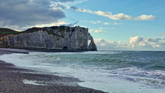 Winter sea waves crash near Aval cliff in Etretat, Normandy in France