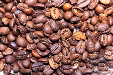 Fototapeta premium Aromatic roasted coffee beans pile texture background for delicious beverage and energy drink concept