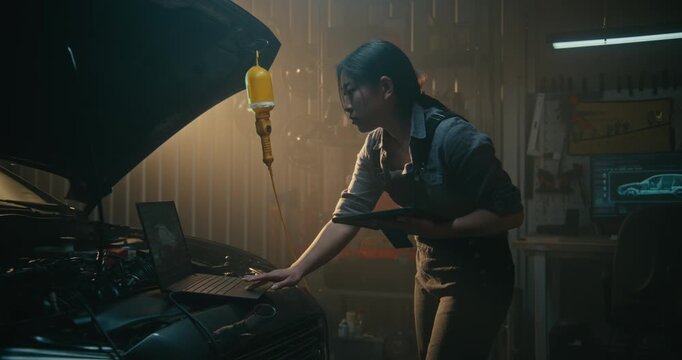 Skilled Female Automotive Specialist Leans Over Engine Bay, Running Diagnostic Software. Tablet Interface With AI Tools Helps Woman Interpret Data and Identify Necessary Adjustments in Vehicle System.