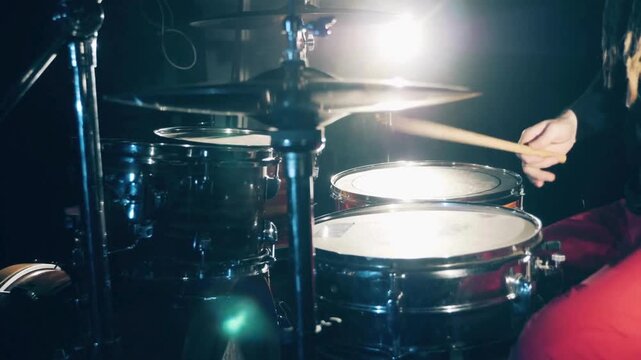 musician drummer holding drum sticks hitting on crash cymbal on dark background Rock music concert gig or rehearsing in studio with band Hands of