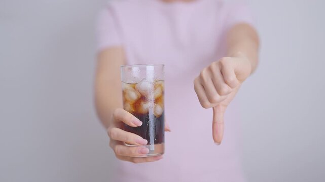 Healthy woman hand thumbs down to soft drink and soda, say no to sugar and carbonated beverage, healthy lifestyle, Acid reflux, Heartburn and Gastritis concept