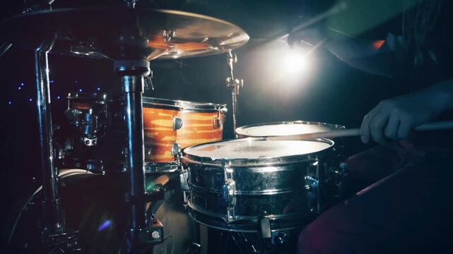 Drummer man playing drums percussion with drum sticks, Close Up Portrait of a Drummer Playing the Drums drum set on concert stage, sticks and drums