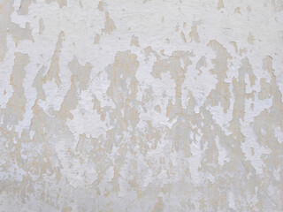 Fototapeta premium Texture of an old white concrete wall with peeling paint and weathered surfaces. This distressed grunge background features vintage architectural details, perfect for industrial design themes.