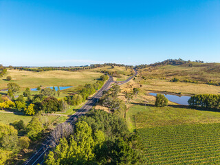 Naklejka premium Aerial View of Mitchell Highway and Northern Distributor Road Winding Through Rural Hills and Vineyards Near Orange