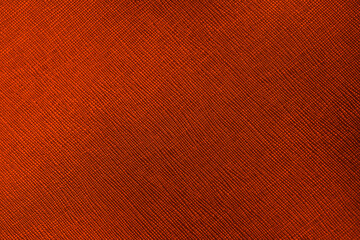 Fototapeta premium Close up abstract textured rustic burnt orange fabric background with diagonal woven pattern