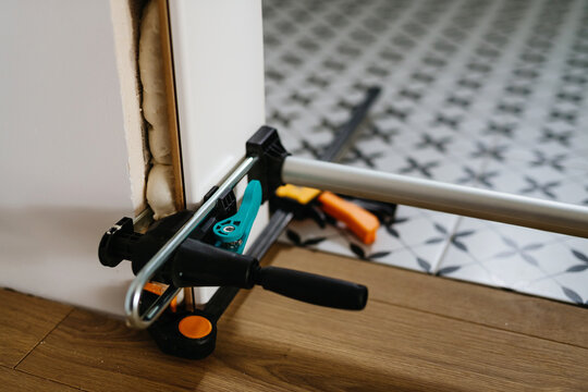 Close up on clamps on door frame during home renovation.
