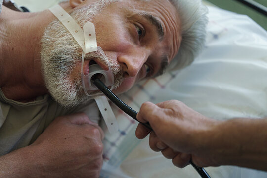 Gastroscopy procedure on sedated patient to examine upper digestive tract.