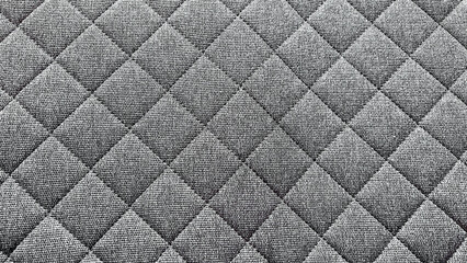 Fototapeta premium Dark gray quilted textile with elegant diamond pattern forming an abstract background design