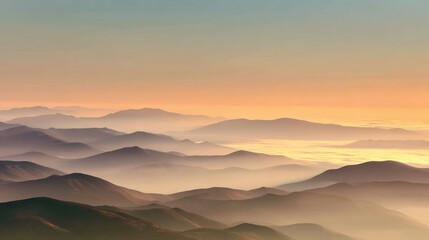 Obraz premium Serene Sunrise Over Rolling Hills and Mountains with Soft Fog in the Valley Creating a Dreamy Landscape Atmosphere