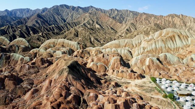 Aerial drone view of Zhangye Danxia landforms with the Qilian Mountains in the background, Gansu Province, China