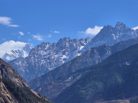 Panoramic view of the majestic Nanda Devi peak peaking through the Himalayan ranges in Uttarakhand, India.