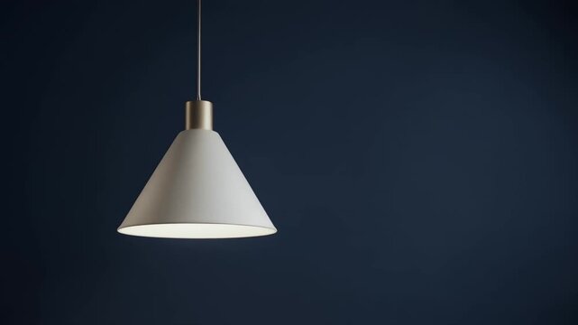A bright white hanging lamp shines against a dark background indoors.