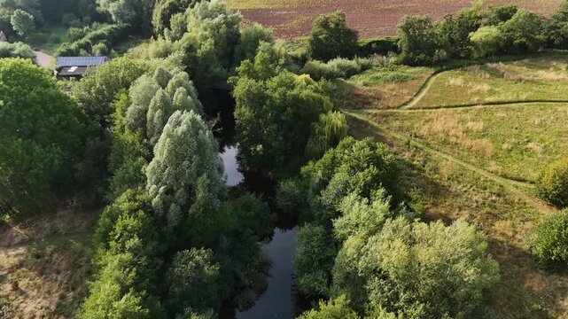 Skenfrith Herefordshire flight along the tree lined river showing cultivated fields on bright sunny Summer Day