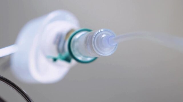 drip in focus Closeup footage of a slow pan down of the IV drip set on IV pole in a black background Intravenous saline solution Slow move around IV