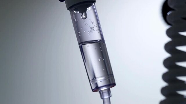 close up equipment in clinic background 4K Intravenous drip in Smooth movement experienced assistant treating a patient Dripping medical perfusion