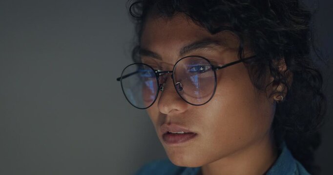 Close-up Black female programmer with code reflection in glasses working late in home office at night. Cybersecurity, AI algorithm, Network security, software developer, serious face, burnout concept.