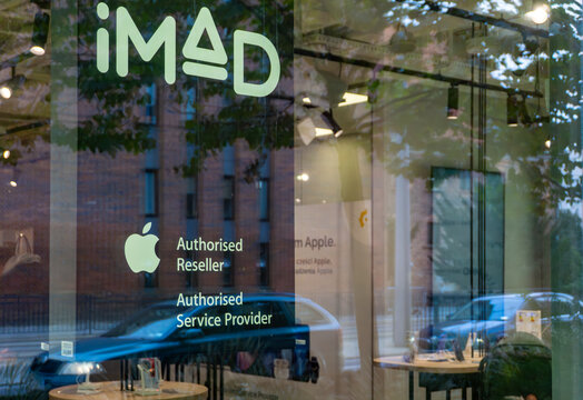 iMad Apple Authorised Reseller and Service Provider storefront, premium electronics store window, professional iPhone and Mac repair services, official Apple partner shop, high-tech retail interior wi