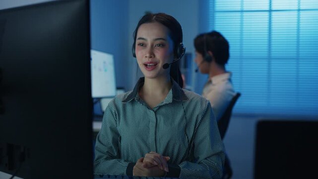 Gen z Asia young call center team or customer support service executive use computer and microphone headset work technical e commerce support in late night office. Telemarketing or sales job concept.