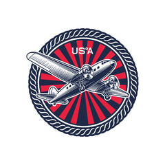 Vintage military insignia featuring a usa biplane in flight on a patriotic background © FahimStock