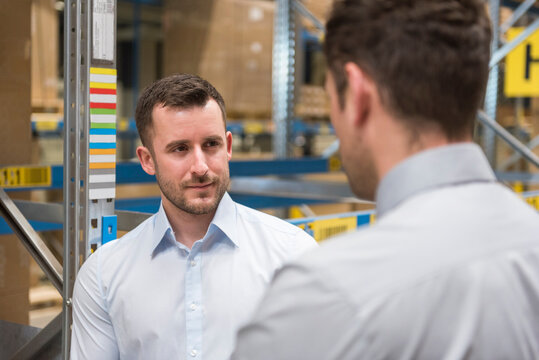 Two men in factory warehouse