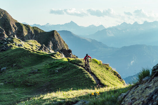 Mountainbiker on a way on a ridge, Grisons, Switzerland
