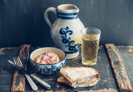 Glass and jar of Hessian cider, bread and bowl of hand cheese