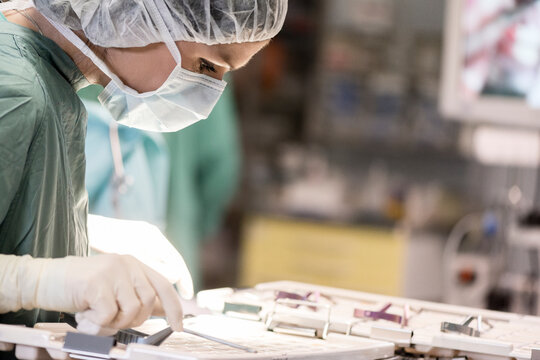 Operating room nurse looking for an instrument
